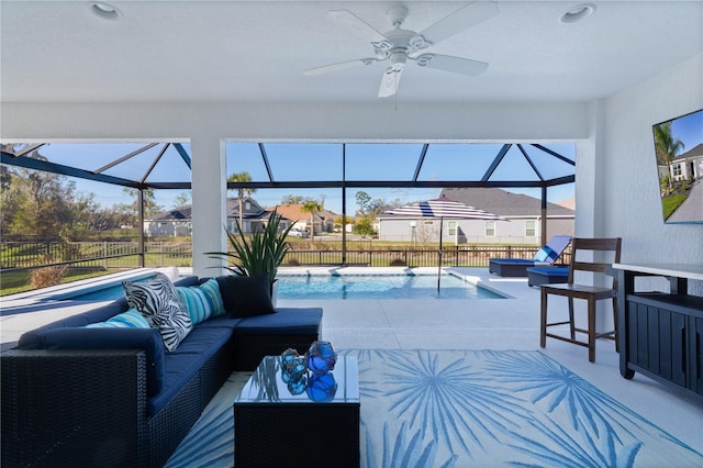 living room with carpet floors, ceiling fan, and a sunroom