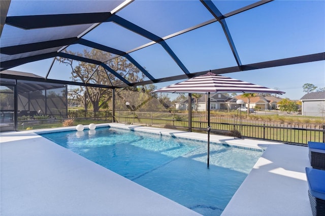 view of pool with a fenced in pool, glass enclosure, and a patio area