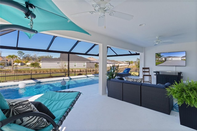 view of pool with a patio, a ceiling fan, a fenced backyard, a lanai, and an outdoor hangout area