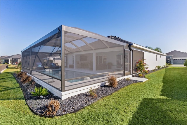 back of property with glass enclosure, a patio, a yard, an outdoor pool, and stucco siding