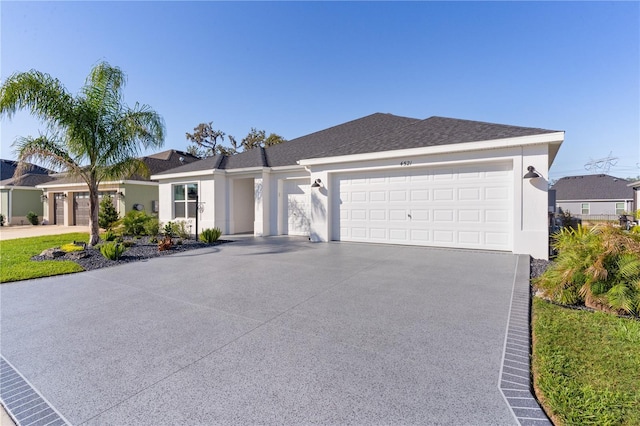 ranch-style house with stucco siding, concrete driveway, and an attached garage