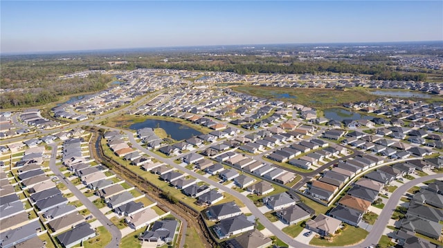 birds eye view of property with a residential view and a water view