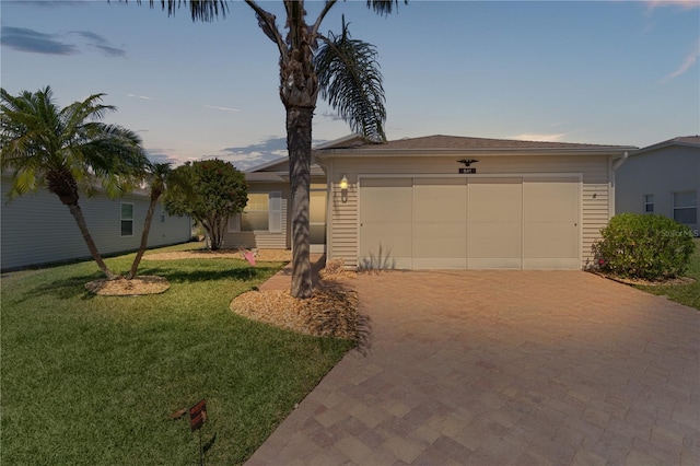 view of front of house with a front lawn, an attached garage, and driveway