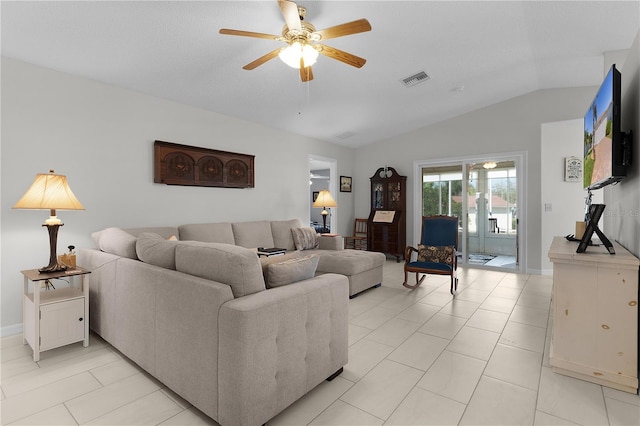 living area featuring lofted ceiling, light tile patterned flooring, a ceiling fan, and visible vents