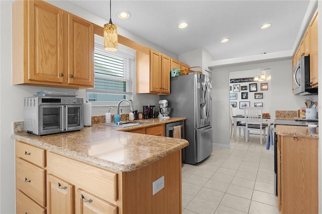 kitchen featuring a sink, decorative light fixtures, recessed lighting, appliances with stainless steel finishes, and light tile patterned floors