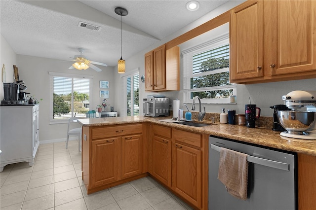 kitchen with visible vents, a peninsula, ceiling fan, a sink, and stainless steel dishwasher