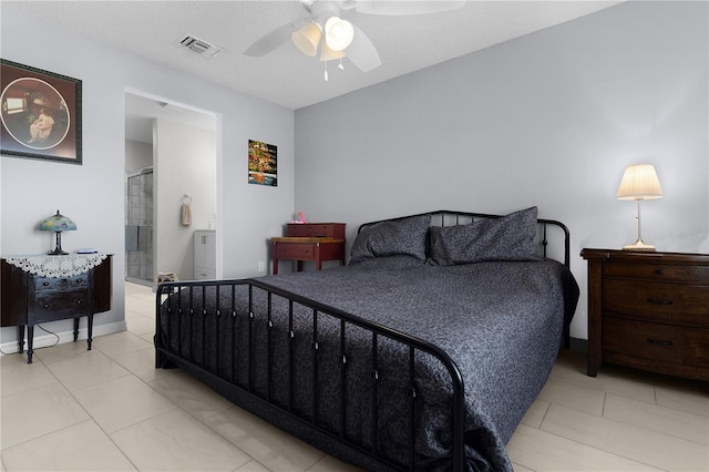 bedroom with visible vents, a textured ceiling, ensuite bathroom, and a ceiling fan