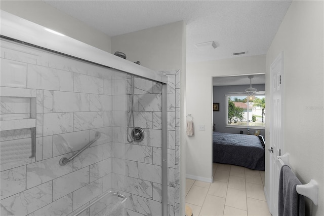 ensuite bathroom with visible vents, a stall shower, a textured ceiling, connected bathroom, and baseboards