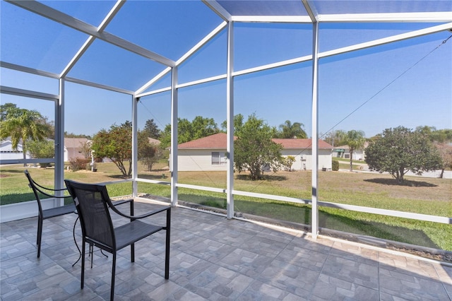 unfurnished sunroom featuring vaulted ceiling