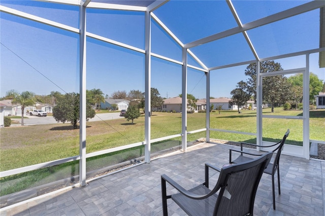 unfurnished sunroom with a residential view and vaulted ceiling