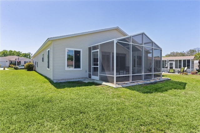 rear view of property with a yard