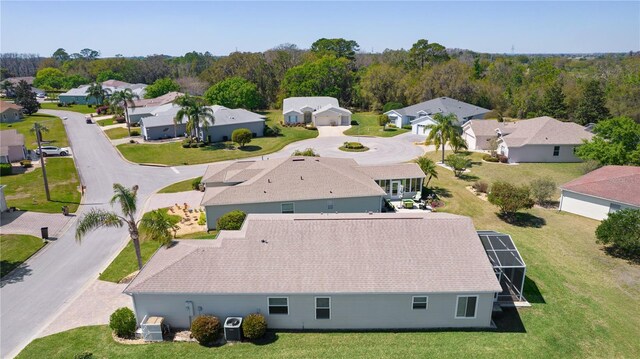 birds eye view of property featuring a forest view and a residential view