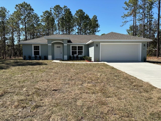 ranch-style house featuring stucco siding, an attached garage, concrete driveway, and a front yard