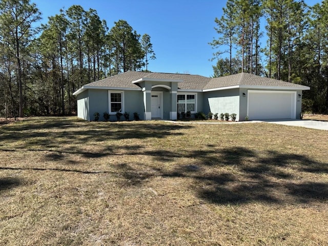 ranch-style home with concrete driveway, a front yard, roof with shingles, stucco siding, and an attached garage