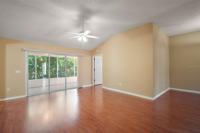 unfurnished room featuring vaulted ceiling, baseboards, a ceiling fan, and wood finished floors