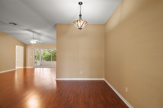 spare room with visible vents, baseboards, a ceiling fan, and wood finished floors