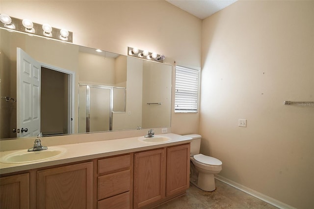 bathroom featuring a sink, toilet, a stall shower, and double vanity