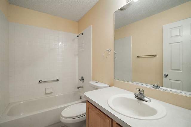 bathroom featuring vanity, toilet, bathing tub / shower combination, and a textured ceiling