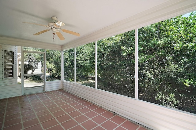 unfurnished sunroom with ceiling fan