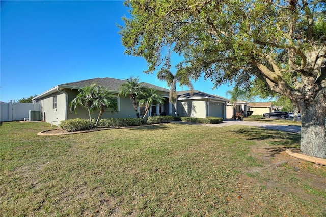 ranch-style home featuring fence, a front yard, stucco siding, a garage, and driveway