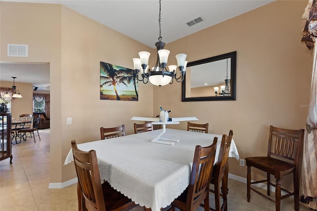 dining space with light tile patterned flooring, visible vents, baseboards, and an inviting chandelier