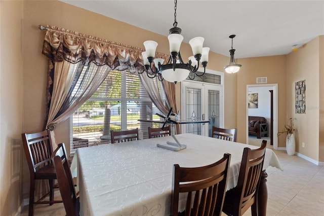 dining area featuring an inviting chandelier, light tile patterned floors, visible vents, and baseboards