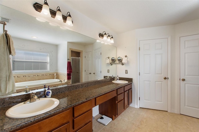 full bath featuring visible vents, a garden tub, a sink, tile patterned flooring, and double vanity