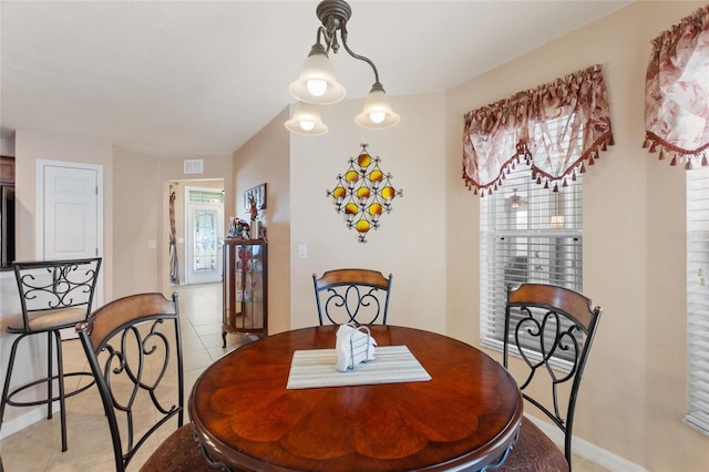 dining room featuring light tile patterned floors and visible vents