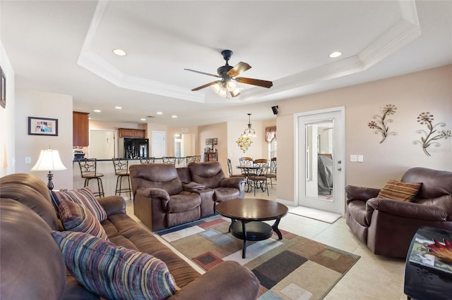 living area featuring ornamental molding, a ceiling fan, a tray ceiling, recessed lighting, and light tile patterned floors