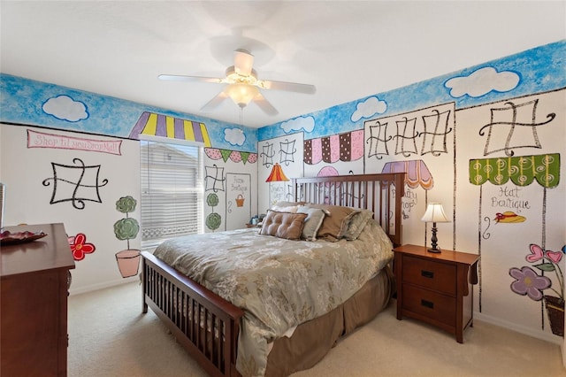 bedroom featuring light colored carpet, a ceiling fan, and baseboards