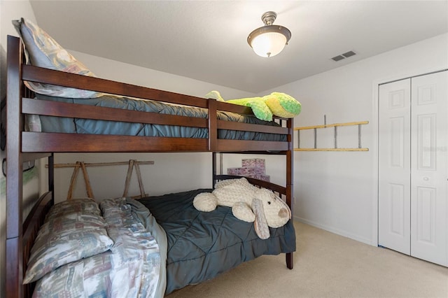 bedroom featuring visible vents, baseboards, a closet, and carpet flooring