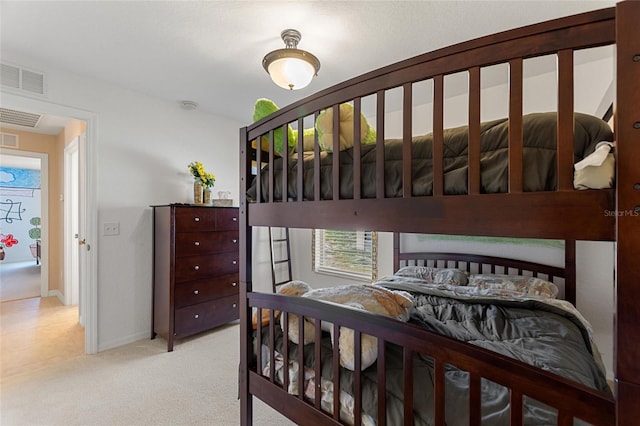 carpeted bedroom featuring baseboards and visible vents