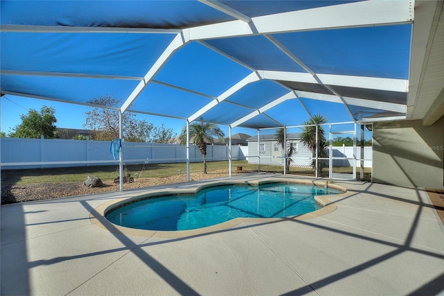 view of pool with a patio area, a fenced backyard, and an outbuilding