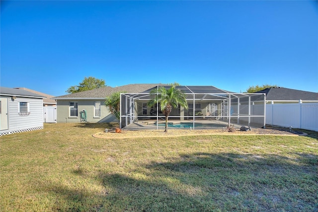 back of house featuring glass enclosure, a yard, a fenced backyard, an outdoor pool, and stucco siding