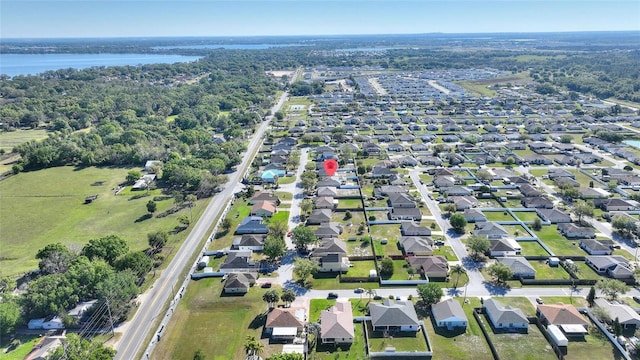 birds eye view of property featuring a residential view and a water view