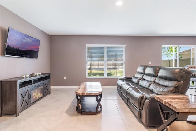 living area with light tile patterned flooring and baseboards