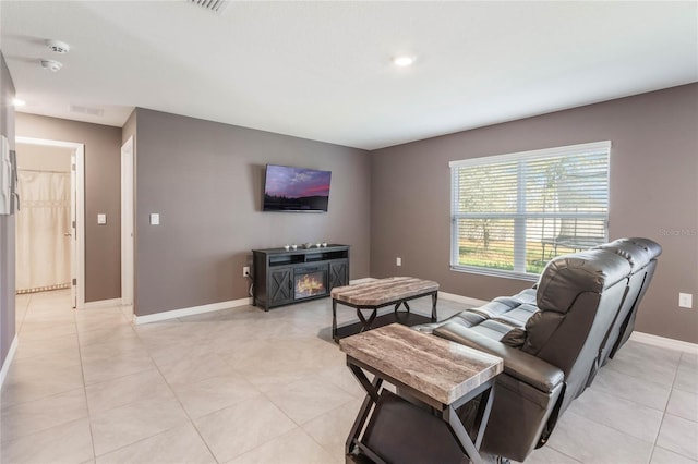 living room with light tile patterned floors and baseboards