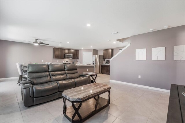 living area featuring recessed lighting, baseboards, ceiling fan, and light tile patterned flooring