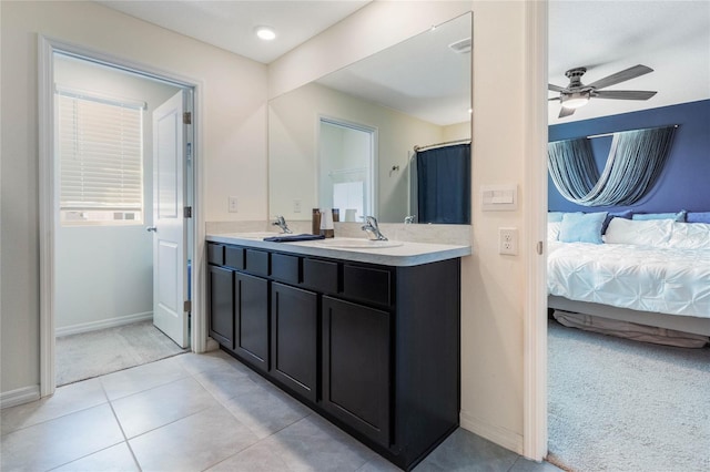 full bath featuring ceiling fan, tile patterned floors, connected bathroom, and a sink