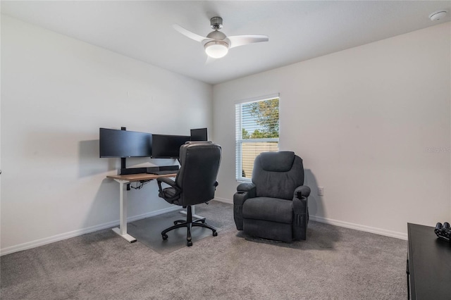office space featuring baseboards, ceiling fan, and carpet floors