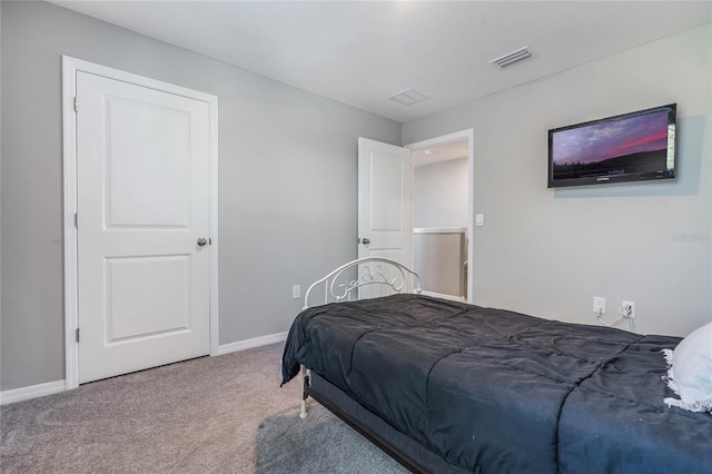 carpeted bedroom with visible vents and baseboards