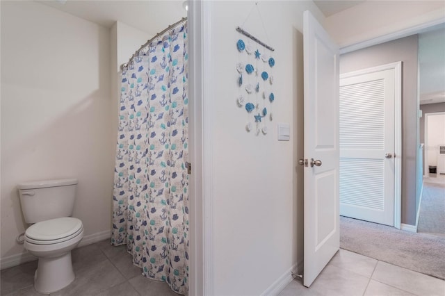 full bath with a shower with shower curtain, tile patterned floors, toilet, and baseboards