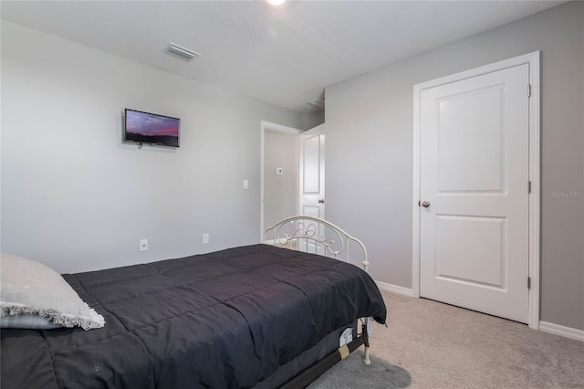 bedroom featuring visible vents, baseboards, and light colored carpet