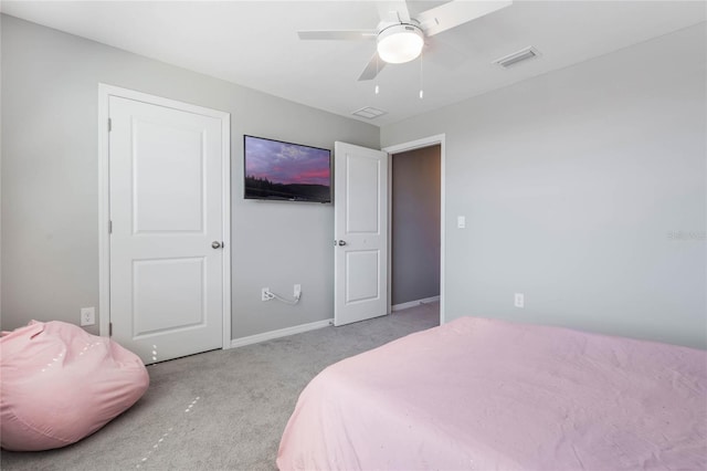 carpeted bedroom featuring visible vents, baseboards, and ceiling fan