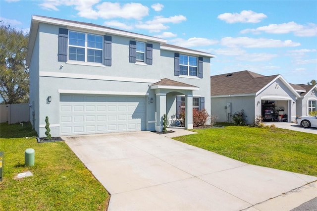 traditional-style home featuring fence, a front yard, stucco siding, a garage, and driveway