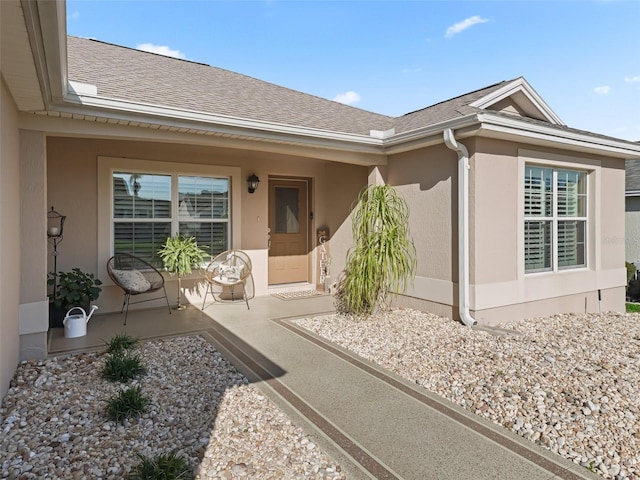 doorway to property with stucco siding