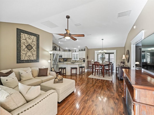 living area with visible vents, ceiling fan, dark wood-type flooring, and lofted ceiling