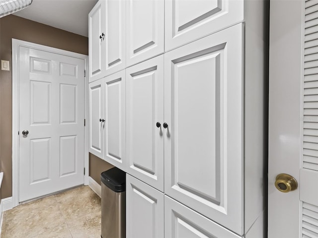 interior space featuring light tile patterned floors and baseboards