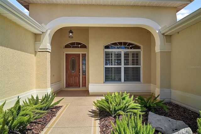 doorway to property with stucco siding