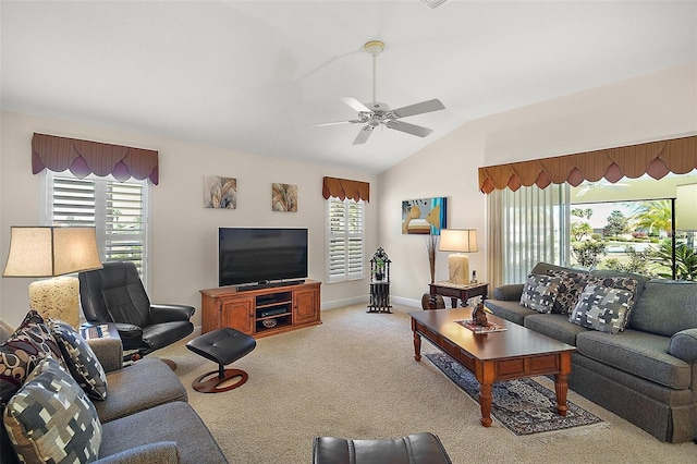 carpeted living room featuring baseboards, ceiling fan, and vaulted ceiling